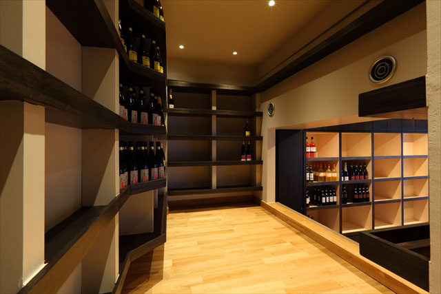 中2階のワイン庫。オーク材の無垢フローリングと合わせ、黒く着色したワイン棚は大容量です。